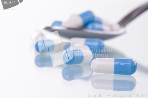 Image of pills on a spoon