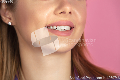 Image of Caucasian young woman\'s close up portrait on pink studio background, emotional and expressive