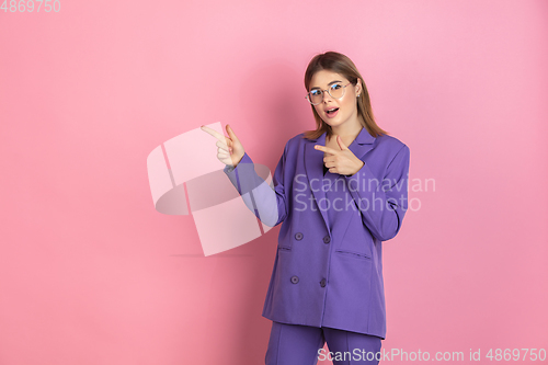 Image of Caucasian young woman\'s portrait on pink studio background, emotional and expressive