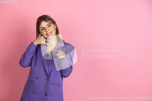 Image of Caucasian young woman\'s portrait on pink studio background, emotional and expressive