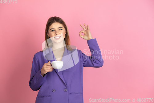 Image of Caucasian young woman\'s portrait on pink studio background, emotional and expressive