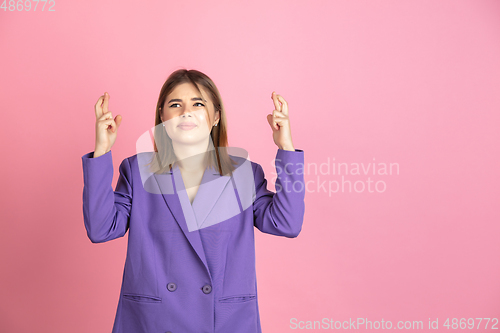 Image of Caucasian young woman\'s portrait on pink studio background, emotional and expressive