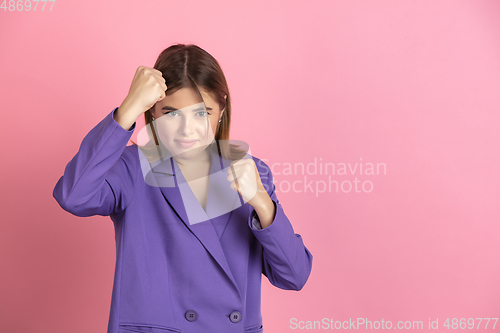 Image of Caucasian young woman\'s portrait on pink studio background, emotional and expressive