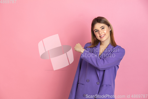 Image of Caucasian young woman\'s portrait on pink studio background, emotional and expressive