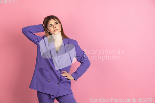 Image of Caucasian young woman\'s portrait on pink studio background, emotional and expressive
