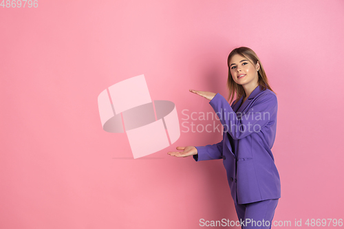 Image of Caucasian young woman\'s portrait on pink studio background, emotional and expressive