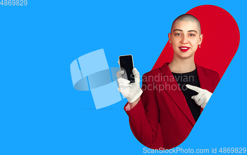 Image of Portrait of young woman with freaky appearance on bright bicolor background with geometric style