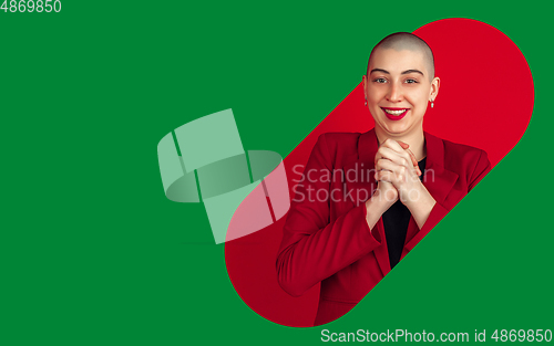 Image of Portrait of young woman with freaky appearance on bright bicolor background with geometric style