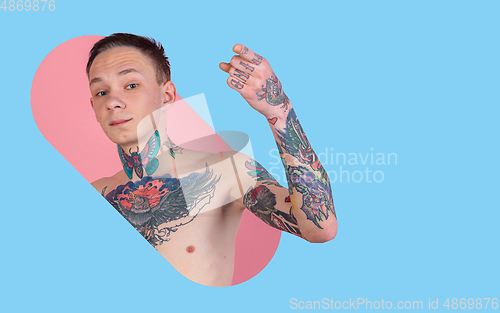 Image of Portrait of young man with freaky appearance on bright bicolor background with geometric style, modern design, artwork