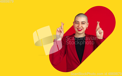 Image of Portrait of young woman with freaky appearance on bright bicolor background with geometric style