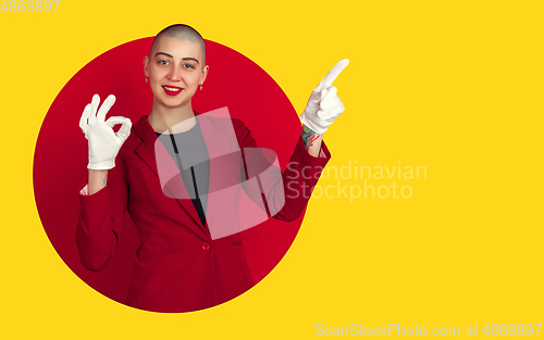 Image of Portrait of young woman with freaky appearance on bright bicolor background with geometric style