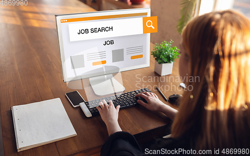 Image of Woman typing while looking for a job during worldwide crisis of coronavirus pandemic. Find a job online. Business, internet and networking concept.