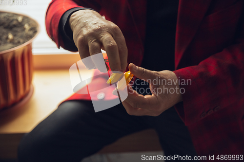 Image of Close up of senior man with retro toys, meeting things from the past and having fun, exploring the lifestyle of the nineties, playing with yo-yo