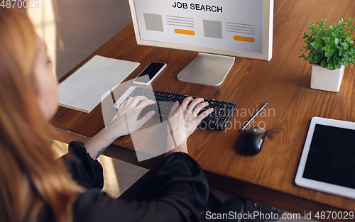 Image of Close up woman typing while looking for a job during worldwide crisis of coronavirus pandemic. Find a job online. Business, internet and networking concept.