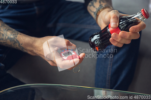 Image of Close up of millenial boy using retro toys, meeting things from the past and having fun, exploring tamagotchi, virtual pet game