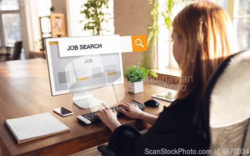 Image of Woman typing while looking for a job during worldwide crisis of coronavirus pandemic. Find a job online. Business, internet and networking concept.