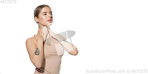 Image of Beautiful young woman massaging her skin over white background. Cosmetics and makeup, natural and eco treatment, skin care. Flyer with copyspace.