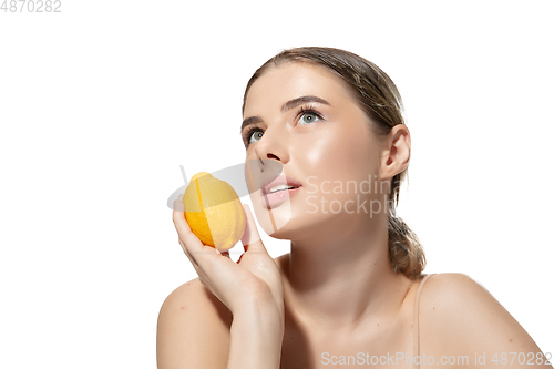 Image of Dreams. Beautiful young woman with orange over white background. Cosmetics and makeup, natural and eco treatment, skin care.