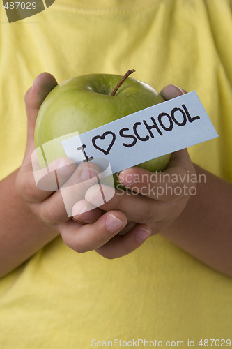 Image of detail of a kid hands with a apple