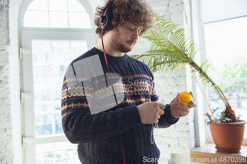 Image of Portrait of millenial boy using retro toys, meeting things from the past and having fun, nostalgic, playing yo-yo