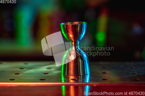 Image of Close up of alcoholic shot in multicolored neon light