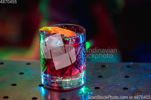 Image of Close up of alcoholic cocktail, beverage, drink in multicolored neon light