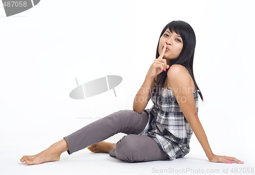 Image of asian with finger on her lips