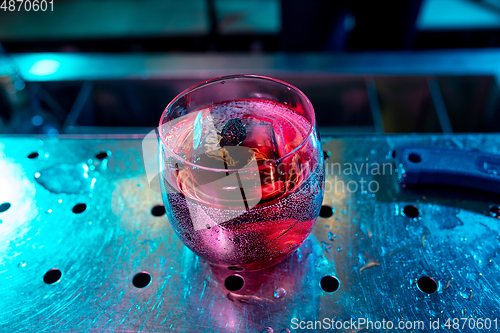 Image of Close up of alcoholic cocktail, beverage, drink in multicolored neon light