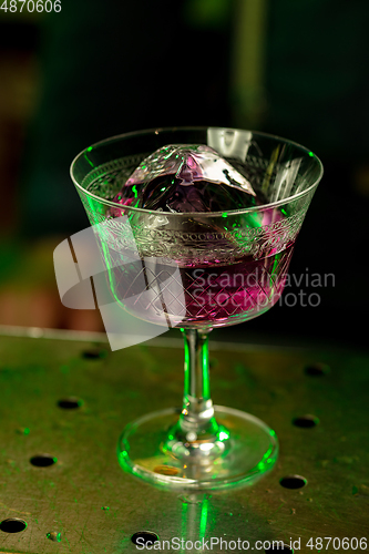 Image of Close up of alcoholic cocktail, beverage, drink in multicolored neon light