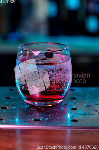 Image of Close up of alcoholic cocktail, beverage, drink in multicolored neon light