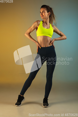 Image of Fashion portrait of young fit and sportive woman on gradient background. Perfect body ready for summertime.
