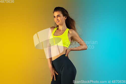 Image of Fashion portrait of young fit and sportive woman on gradient background. Perfect body ready for summertime.