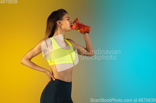 Image of Fashion portrait of young fit and sportive woman on gradient background. Perfect body ready for summertime. Flyer with copyspace.