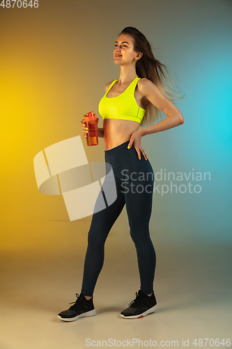 Image of Fashion portrait of young fit and sportive woman on gradient background. Perfect body ready for summertime. Flyer with copyspace.