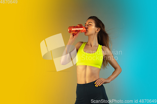 Image of Fashion portrait of young fit and sportive woman on gradient background. Perfect body ready for summertime. Flyer with copyspace.