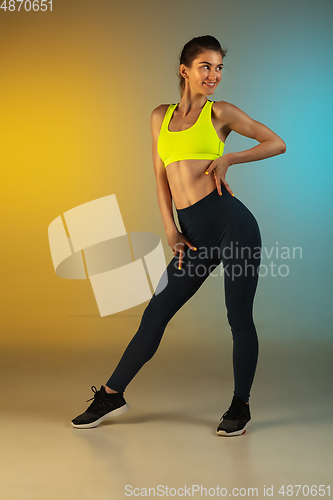 Image of Fashion portrait of young fit and sportive woman on gradient background. Perfect body ready for summertime.