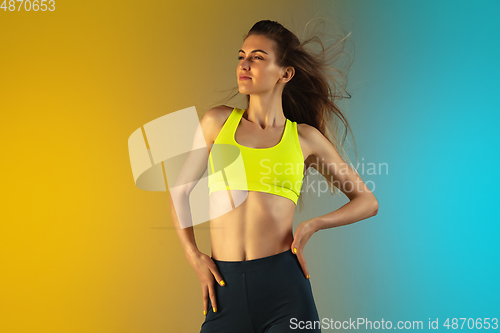 Image of Fashion portrait of young fit and sportive woman on gradient background. Perfect body ready for summertime.