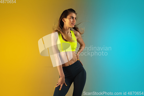 Image of Fashion portrait of young fit and sportive woman on gradient background. Perfect body ready for summertime.