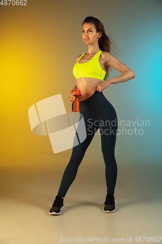 Image of Fashion portrait of young fit and sportive woman on gradient background. Perfect body ready for summertime. Flyer with copyspace.