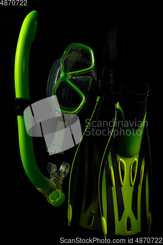 Image of Professional sport equipment isolated on black studio background. Swimming flippers and mask.