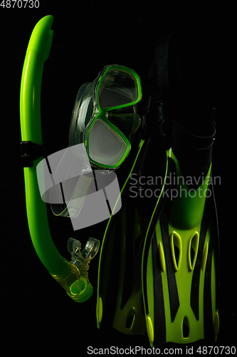 Image of Professional sport equipment isolated on black studio background. Swimming flippers and mask.