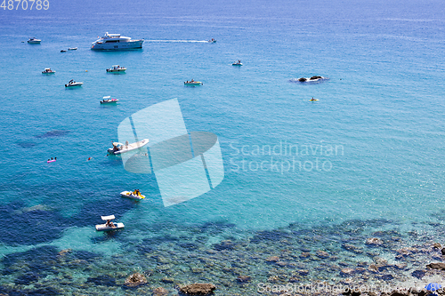 Image of Boats near a rock stone coast. Scenic view of tipycal rocky coas