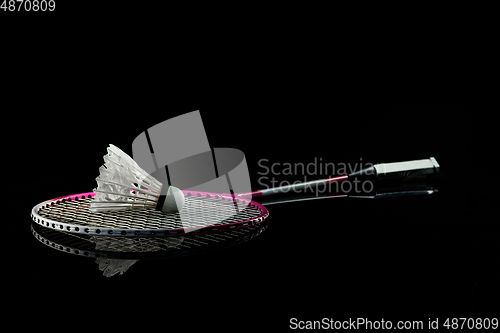 Image of Professional sport equipment isolated on black studio background. Badminton racket.