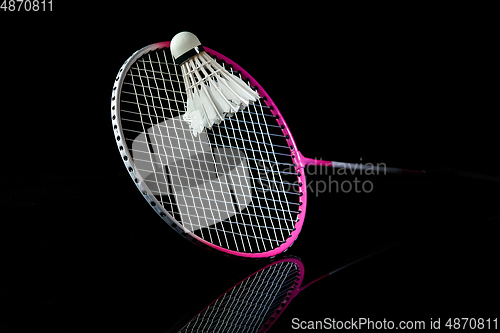 Image of Professional sport equipment isolated on black studio background. Badminton racket.