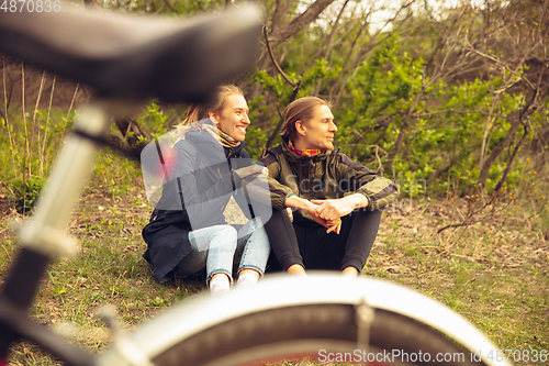 Image of Best friends having fun near countryside park, riding bikes, spending time healthy