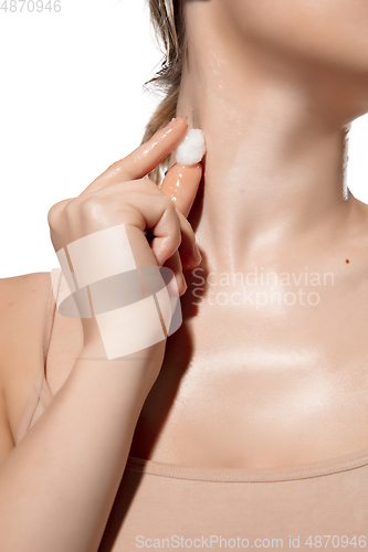 Image of Cold. Close up of beautiful young woman moisturizing neck with ice on white background. Cosmetics and makeup, natural and eco treatment, skin care.