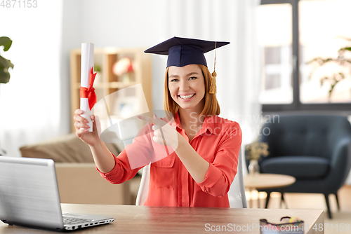 Image of student woman with laptop and diploma at home