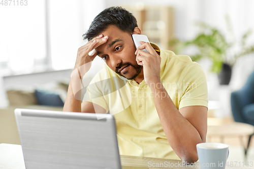 Image of man calling on smartphone at home office