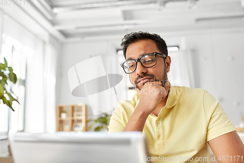 Image of stressed man with laptop working at home office