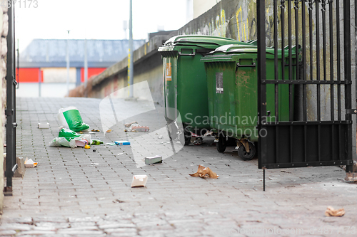 Image of dumpsters on messy city street or courtyard